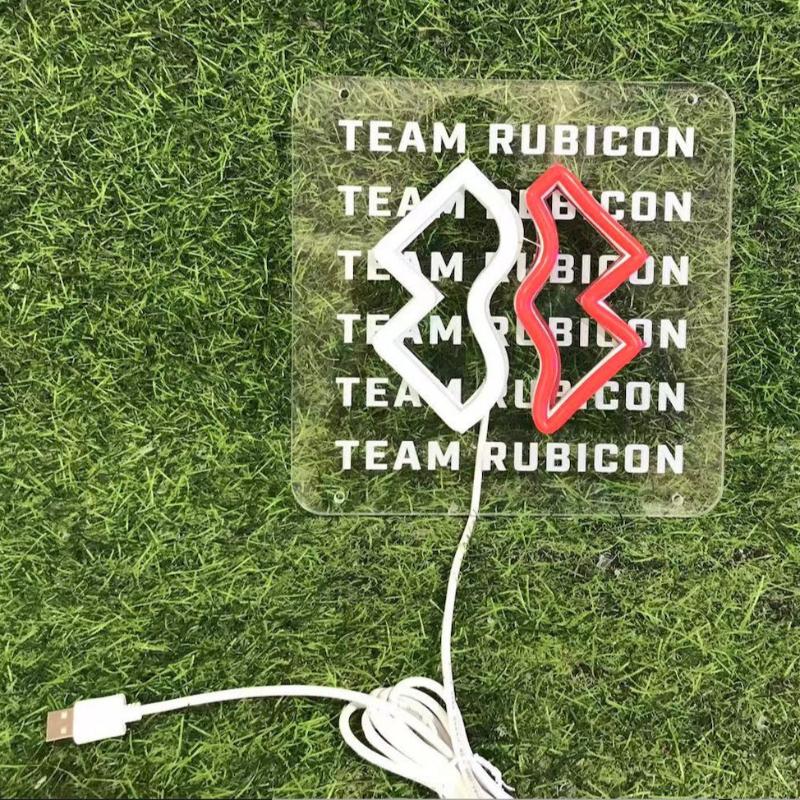 unlit neon sign on grass