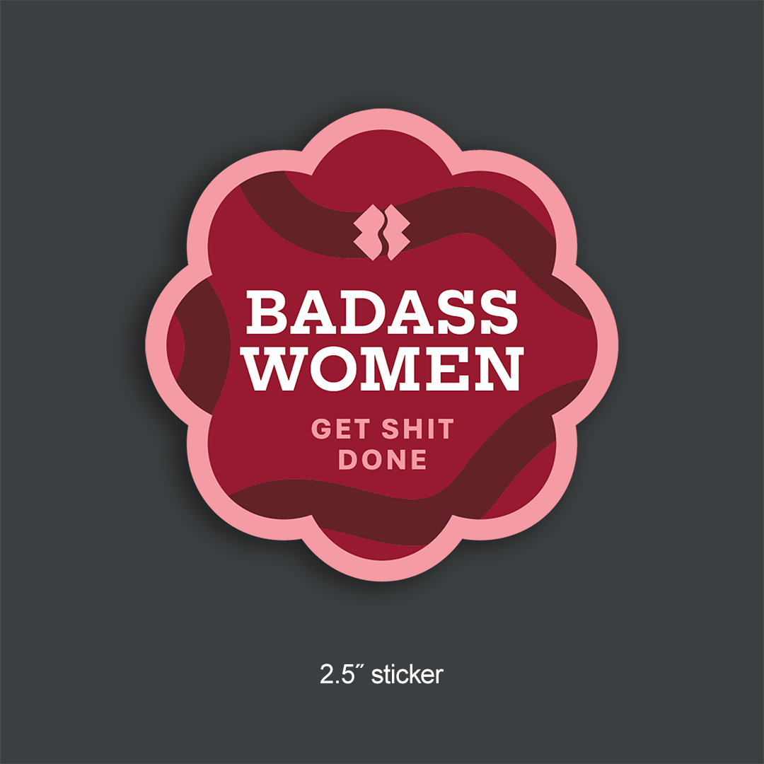 Sticker with scalloped edges with 'BADASS WOMEN GET SHIT DONE' text in the center, background is a mix of pinks and reds