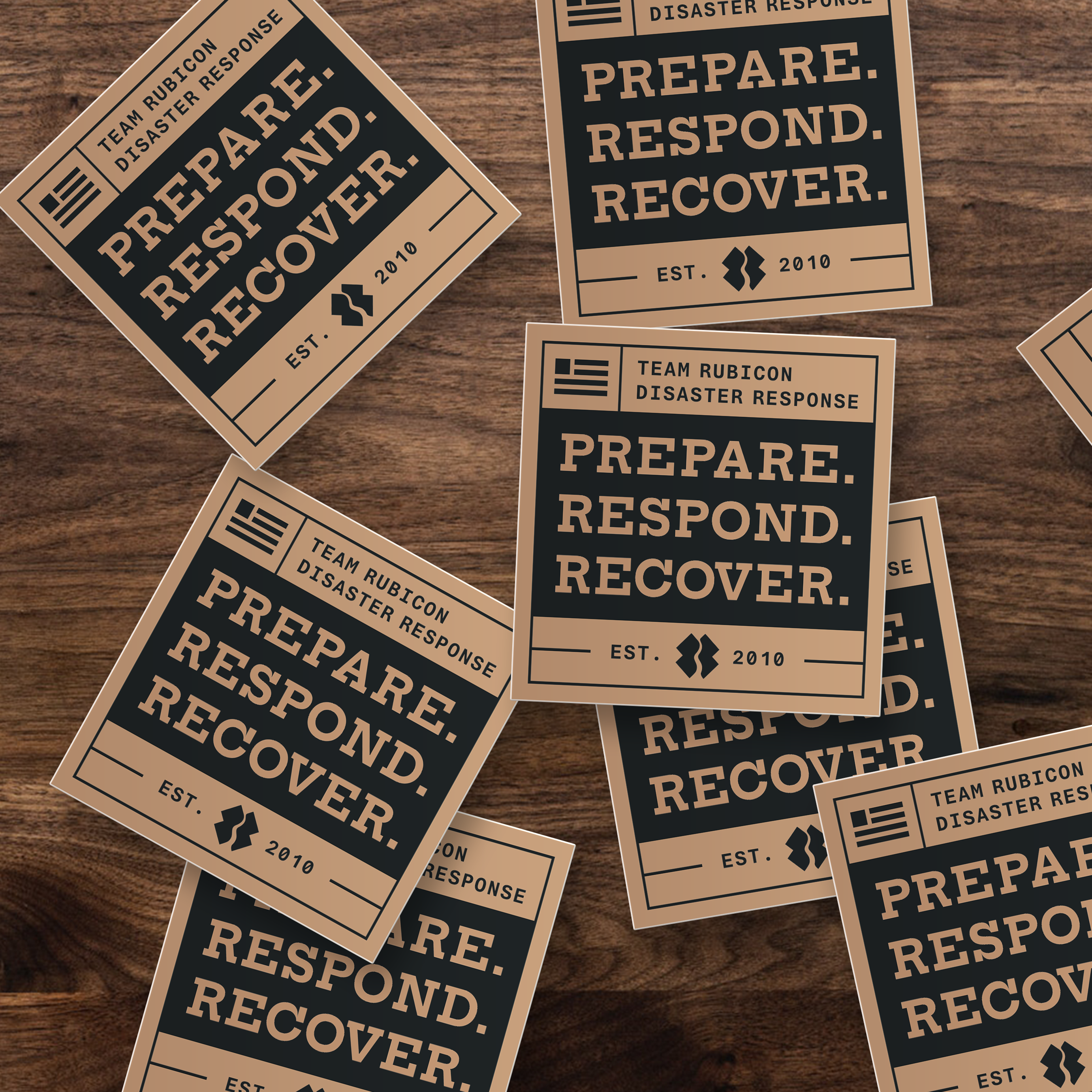 Several tan and dark teal rectangular stickers or cards with the text 'PREPARE. RESPOND. RECOVER.' and 'TEAM RUBICON'
